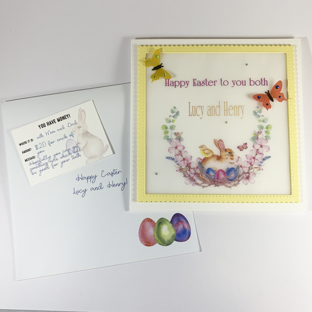 This is an image of the matching envelope, a gift card and the card. The envelope has three coloured Easter Eggs in the bottom right hand corner. It also has a example message written on it for the recipient. The gift tag is white and is a "You Have Money" tag containing the information of where the money is, how much and a message.