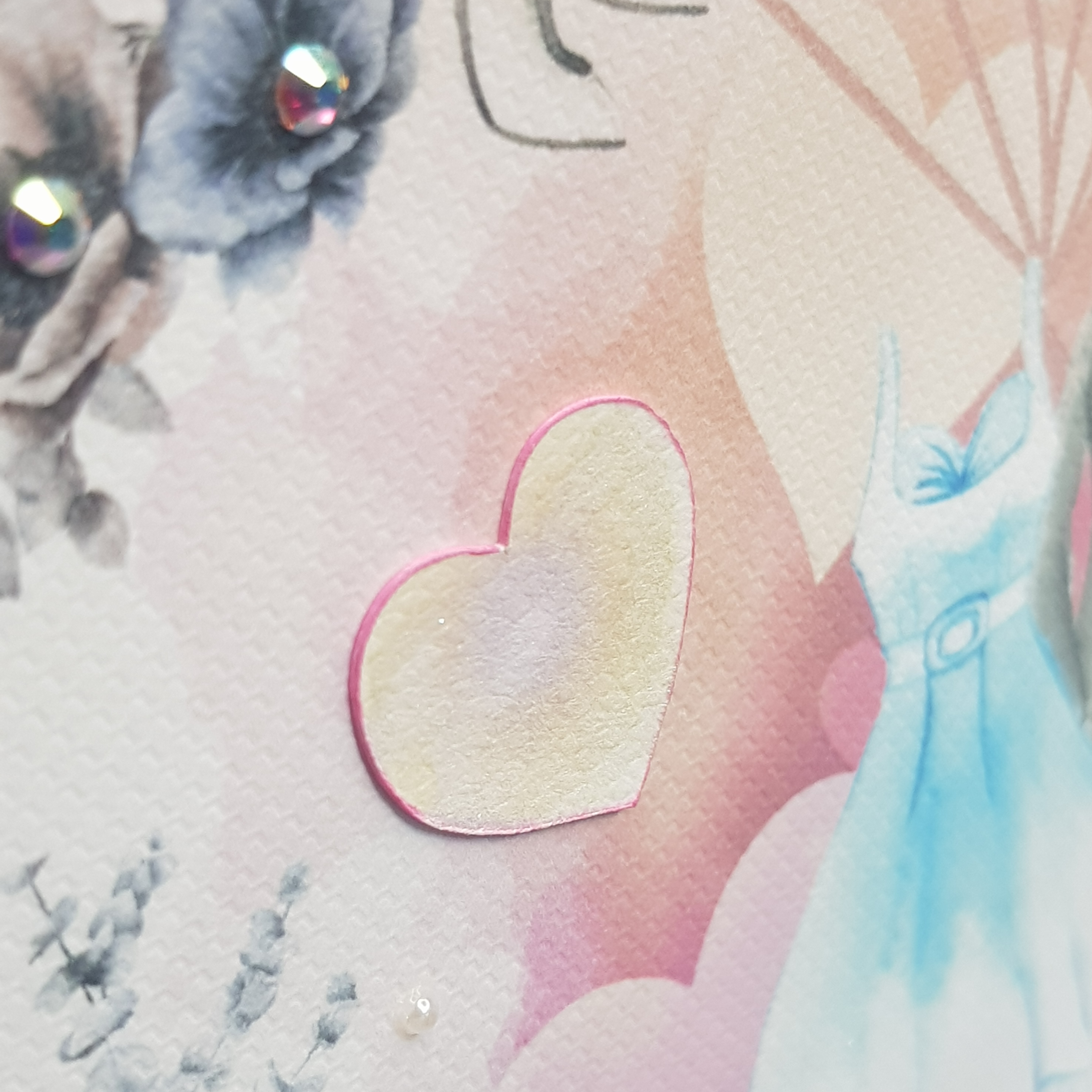 closeup showing detail of woven texture cardstock, hand finishing and jewels