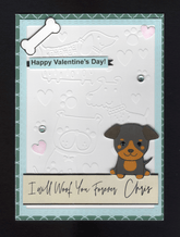 A beautiful card with embossed cartoonlike impressions of various types of dogs, pawprints and hearts on white cardstock forming the background, with gems in two of the paw prints, a cute dogof your choise sits on a beige/blacksentiment strip with the recipients name. A bone and two pink hearts sit proud. A blue faux stitched frame sits over and a teal/light blue moroccan style background completes the look
