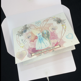 open folder showing luxury personalised watercolour wedding card with blue, pink and yellow hearts, jewels, pearls