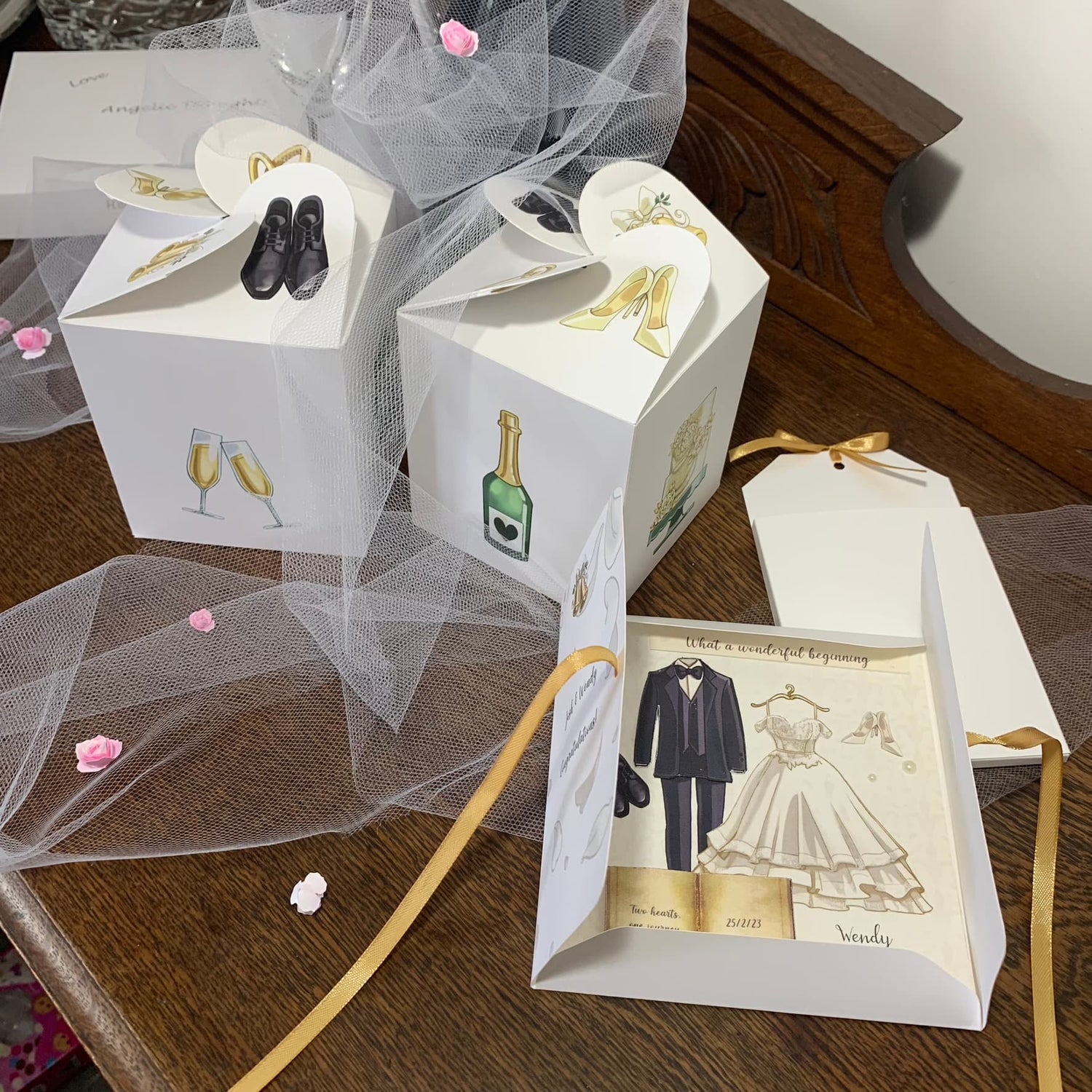 square parchment book wedding card in folder with pair of matching candle