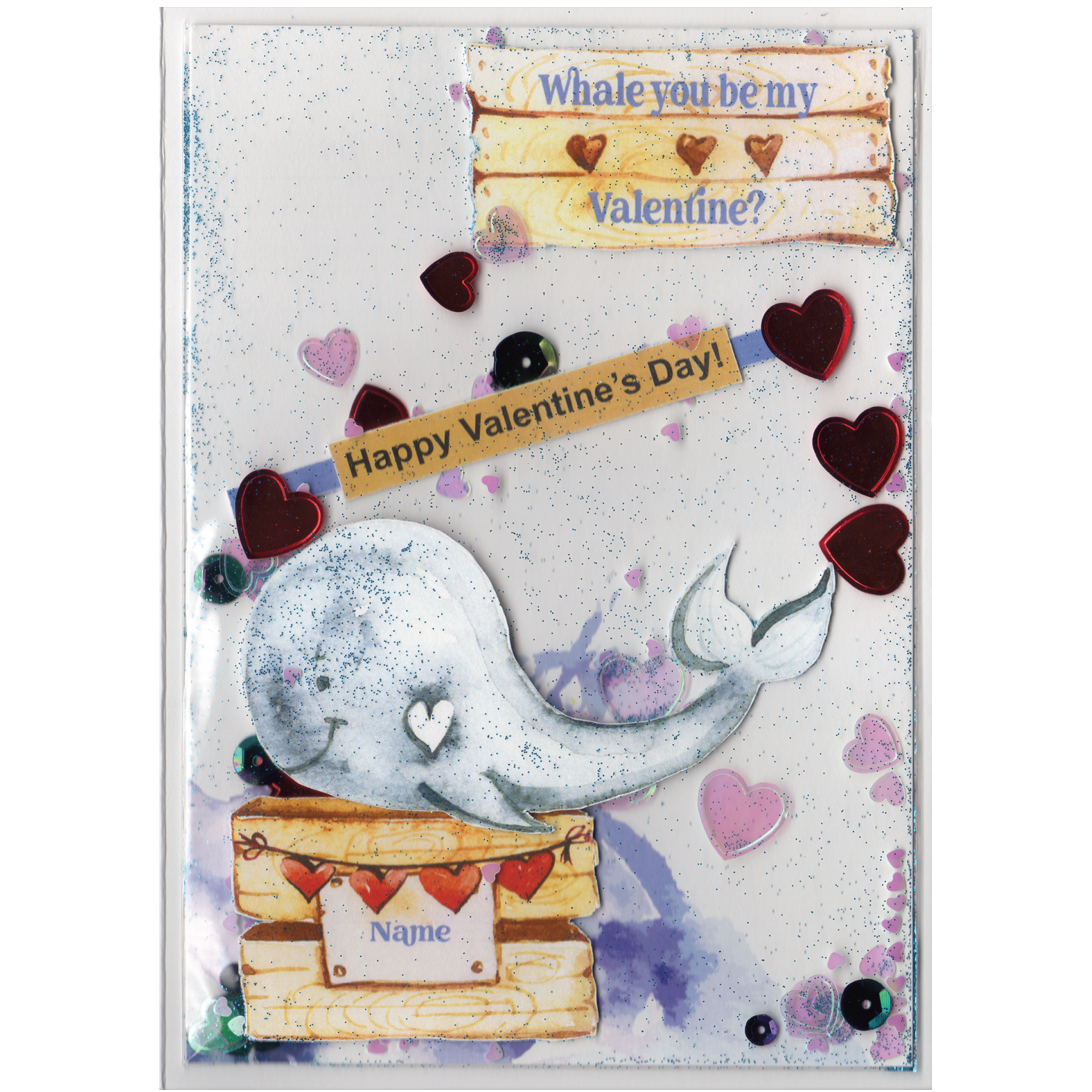 Handmade card featuring a raised cutout whale on a wooden box with heart banner and the customisable name of the recipient. It is fully enclosed in a shaker pocket with irridescent and red hearts of varying sizes and blue glitter.