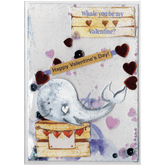 Handmade card featuring a raised cutout whale on a wooden box with heart banner and the customisable name of the recipient. It is fully enclosed in a shaker pocket with irridescent and red hearts of varying sizes and blue glitter.